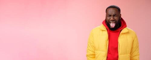 Guy cringing stick burn tongue frowning bothered sip very hot coffee grimcaing aversion dislike expressing childish attitude disliking unwilling go meet girlfriend parents, standing pink background photo