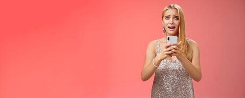 Panicking shocked woman concerned photos leaked internet look afraid anxious widen eyes cringing troubled hold smartphone shook speechless gasping terrified friends find out secret, red background