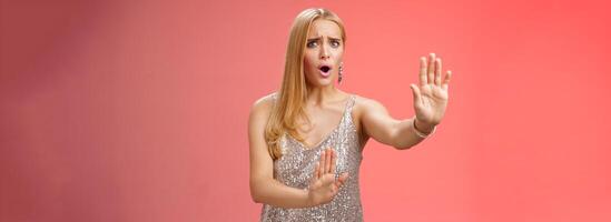 No wow slow down. Portrait freak-out displeased woman hear unpleasant suggestion step back extend arms self-defense asking stop enough give rejection refusal look worried, red background photo