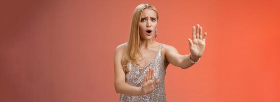 No wow slow down. Portrait freak-out displeased woman hear unpleasant suggestion step back extend arms self-defense asking stop enough give rejection refusal look worried, red background photo