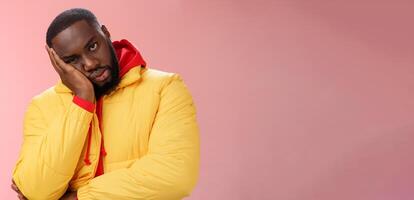 Annoyed bothered pissed african-american bearded man in yellow jacket facepalm look angry camera irritated lean head hand bored fed up pissed hearing uninteresting same stories, pink background photo