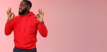 Guy assuring customer like result. Charismatic outgoing african american bearded young guy persuading you everything cool under control show okay ok no problem gesture, smiling assuring all good photo