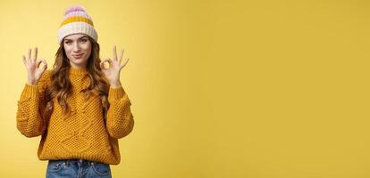 You look awesome. Portrait satisfied good-looking girl show okay gesture delighted good result, excellent perfect work, assuring no problem, smiling devious check out cool shot, yellow background photo