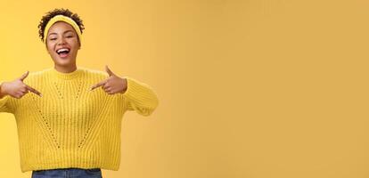 Confident good-looking outgoing black cute girl 20s in sweater headband afro hairstyle pointing heself raise head arrogant laughing bragging telling own personal goals achievements, suggest herself photo