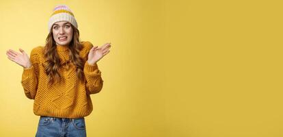 Oops sorry, my fault. Portrait awkward insecure worried cute european 20s girl apologizing making mistake disturbing friend bad temper raising hands surrender cringing confused shrugging photo