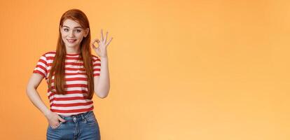 Very good. Pleased cute female showing okay sign and smiling satisfied, grinning delighted recieve positive result, hold hand pocket assertive, self-assured pose, agree, accept terms, recommend photo