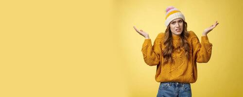 What fuss about. Annoyed confused intense perplexed young attractive woman wearing sweater hat raising hands dismay shrugging cringing grimacing frustrated arguing clueless what happened photo