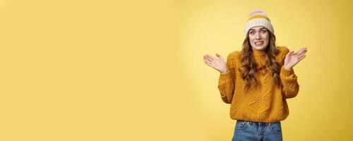 Oops sorry, my fault. Portrait awkward insecure worried cute european 20s girl apologizing making mistake disturbing friend bad temper raising hands surrender cringing confused shrugging photo