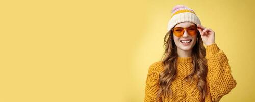 Friendly-looking happy outgoing attractive girl laughing joyfully having funny interesting conversation checking sunglasses relaxing ski resort having fun resting together friends, yellow background photo