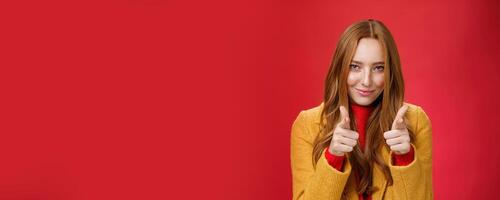 Nice job it was awesome. Portrait of sassy and cheeky good-looking redhead female with freckles and blue eyes smiling sensually with satisfied grin showing thumbs up in approval and like gesture photo