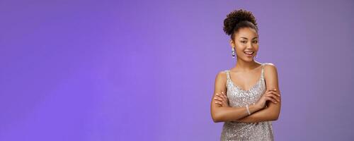 Stylish lucky happy attractive african-american female in glittering silver night-dress cross arms chest self-assured arrogant smiling delighted rejoicing nice interesting evening, satisfied photo