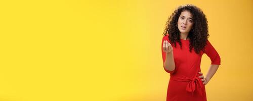 Girl being pissed off arguing ad complaining making italian what do you want gesture looking bothered waiting for explanation as standing annoyed and fed up over yellow background photo
