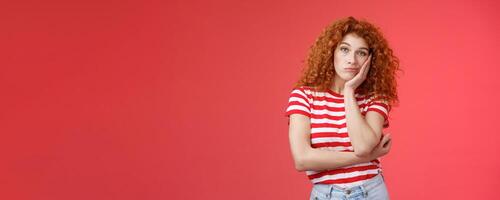 Playful redhead gorgeous girl feel sad lacking energizing party lean palm look indifferent express boredom lonely feelings attend boring meeting standing upset reluctant red background photo