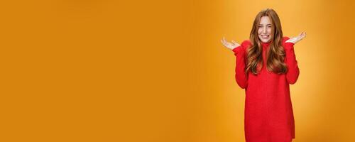 Girl squinting and shrugging as being shouted at frowning being insecure and displeased as listening cursing words and yell raising hands near shoulders in confused gesture, questioned what her fault photo