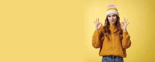 You look awesome. Portrait satisfied good-looking girl show okay gesture delighted good result, excellent perfect work, assuring no problem, smiling devious check out cool shot, yellow background photo