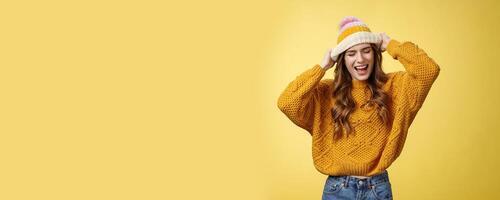 Wild rebellious carefree good-looking stylish caucasian woman having fun screaming out loud careless close eyes touching hat dancing singing favorite music listening songs dress-up university photo