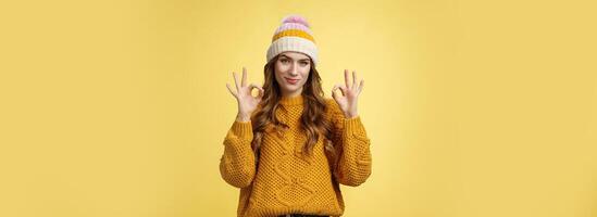 You look awesome. Portrait satisfied good-looking girl show okay gesture delighted good result, excellent perfect work, assuring no problem, smiling devious check out cool shot, yellow background photo