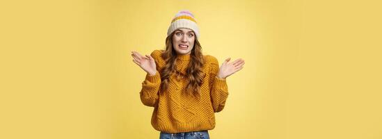 Oops sorry, my fault. Portrait awkward insecure worried cute european 20s girl apologizing making mistake disturbing friend bad temper raising hands surrender cringing confused shrugging photo