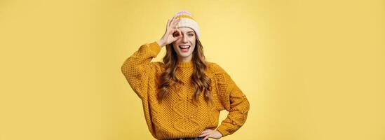 Smiling optimistic happy charming girl show okay ok gesture assuring everthing alright keep up supporting you, like awesome idea excited try out, standing satisfied yellow background photo