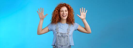 Fine you won. Cheerful carefree playful attractive redhead curly girlfriend having fun laughing out loud joyful raise hands up surrender fool around enjoy cool awesome time spending friend photo