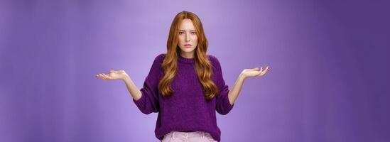 What your problem. Frustrated, confused and annoyed redhead girlfriend arguing cannot get clue why bother shrugging with raised hadns aside and puzzled expression, irritated with stupid quarrel photo
