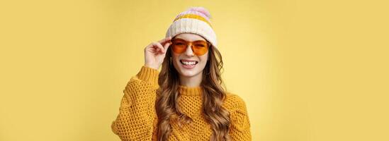 Friendly-looking happy outgoing attractive girl laughing joyfully having funny interesting conversation checking sunglasses relaxing ski resort having fun resting together friends, yellow background photo