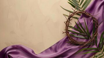 Top view crown of thorns with palm leaf and purple fabric on a beige copy space background photo