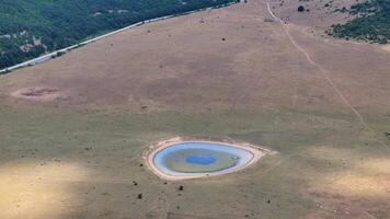 The sun is illuminating a small mountain lake from different angles video