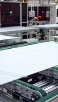 Automated manufacturing process of solar panels. Innovated technology for making solar cells in a robotic factory background. Vertical video