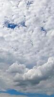 Cloudscape covering the skies and summer sun. Spindrift clouds spreading along the horizon. Low angle view timelapse. Vertical video