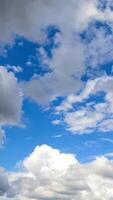 Heavenly beautiful turquoise skies with fluffy clouds quickly transforming in the wind. Spindrift clouds at backdrop. Timelapse. Vertical video