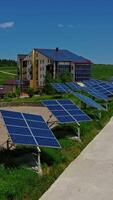 Building with solar panels in nature. Blue sunny batteries along the road. Photovoltaic cells generate ecological energy at sunlight in summer. Vertical video