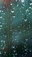 Glass window in rainy weather with raindrops. Falling drops. Wet window with drops and white dots. Close-up. Vertical video