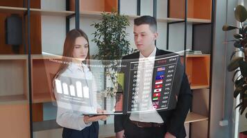Financial analysts consider a holographic display with information on world currencies and cryptocurrencies. Business and technology concept. Display of financial analytics of the future. video