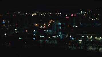 blurred night city background with colored bokeh. View of the city from a height out of focus. video