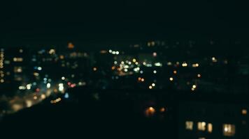 blurred night city background with colored bokeh. View of the city from a height out of focus. video