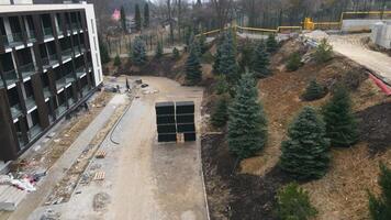 Aerial view Builders paving and creating landscaping on construction sites. Craftsmen pave sidewalks and footpaths. video