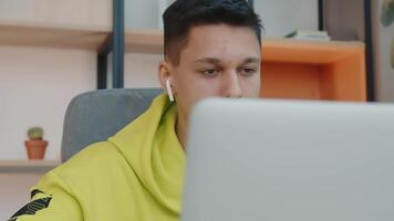 The face of a student sitting in a room at the computer. Close up of a young student's face. video