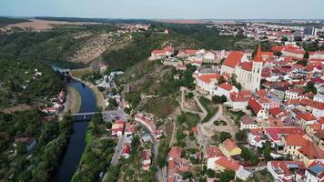 Aerial view of Znojmo city with castle and St. Nicholas cathedral and dam wall on river Dyje in Czechia in August 2024 video