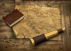 Old world map with telescope photo