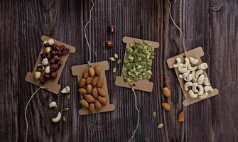 Mix nuts on wooden table,healthy vegan food. photo
