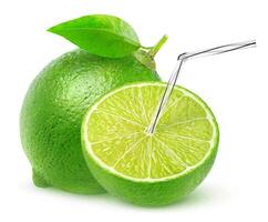 Cut lime with straw in it isolated on white background with clipping path, a natural fresh fruit juice concept photo