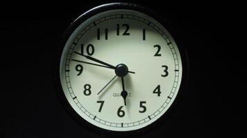 The alarm clock on a black background, in the style of time-lapse . video