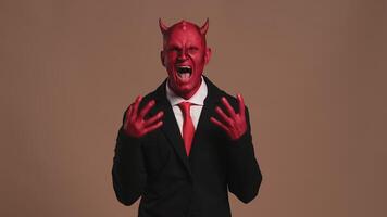 Red devil businessman getting angry on solid background video