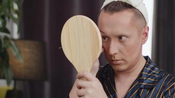 Man applying stage makeup in front of mirror video