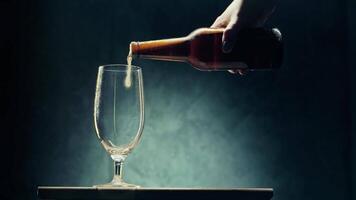 Pouring a refreshing beverage into a glass in a dimly lit setting video