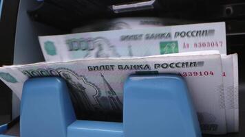 Counting Russian banknotes from an ATM in a busy urban location during daytime operations video