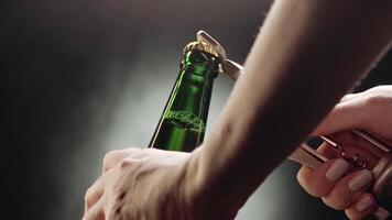 A hands-on guide to opening a bottle with a traditional opener in a dimly lit setting video