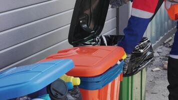 Worker collects recyclables and trash from bins during waste management round in a local neighborhood video