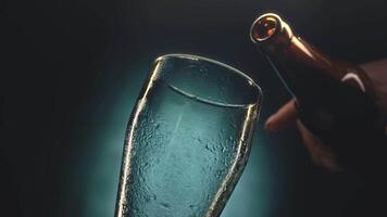 Pouring a refreshing drink in a glass, highlighting the cool condensation and vibrant color in a dimly lit setting video